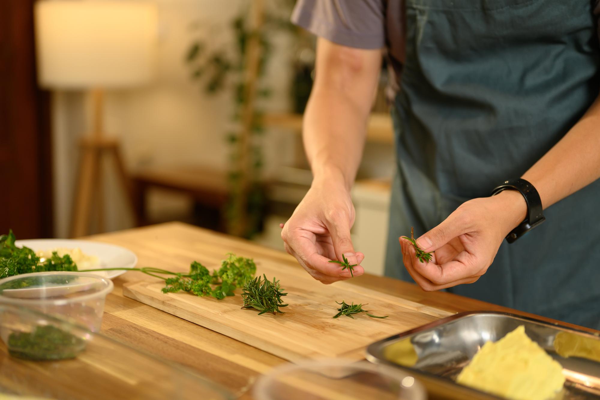 founder arranging herbs on wooden table