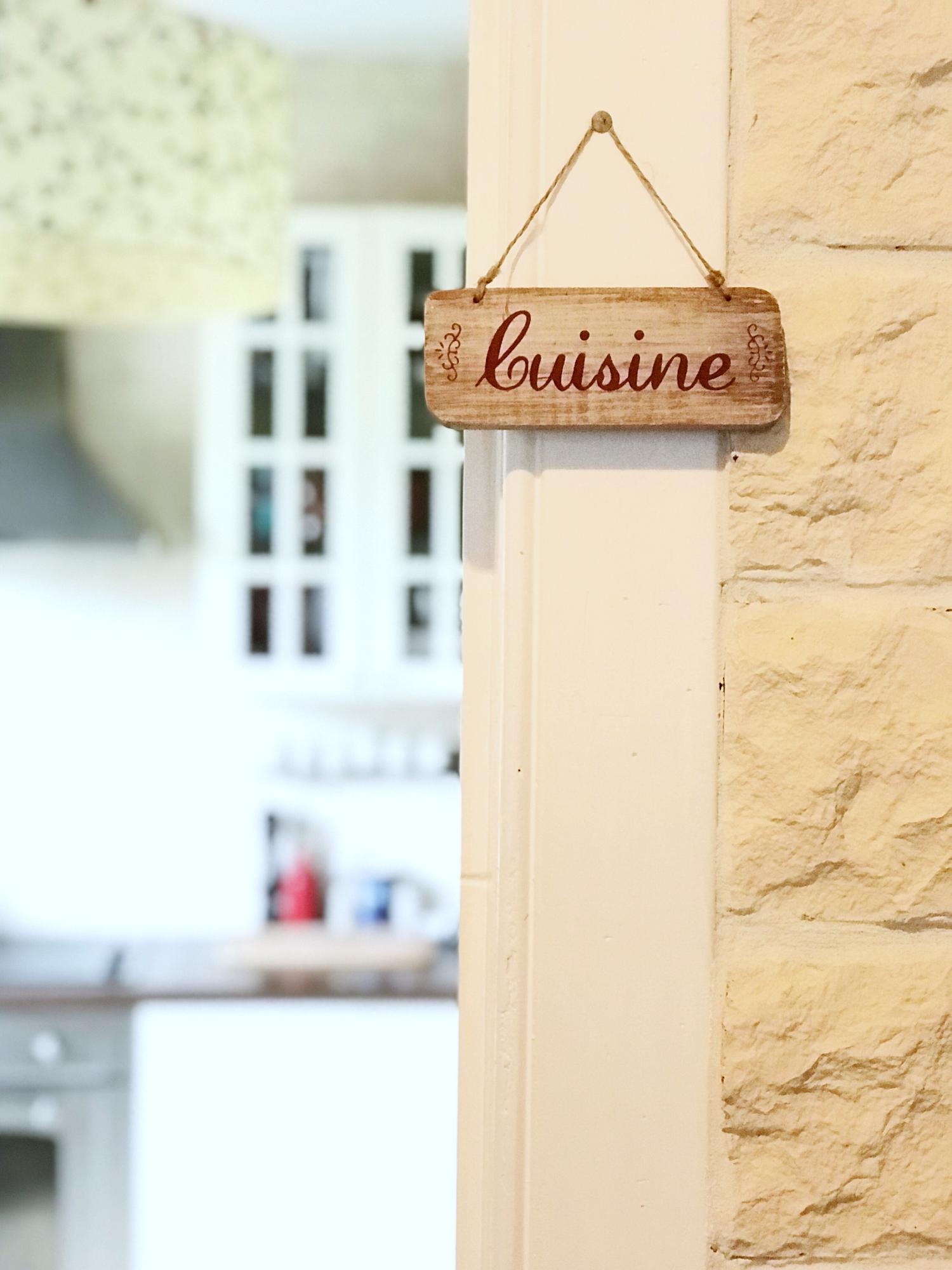 studio exterior with wooden door and sign